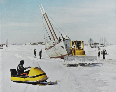 Sailboat during winter being hauled over the ice