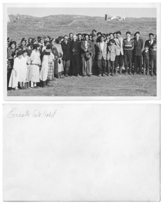 Cree people with a priest pose for a photo