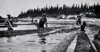 Men in the river moving logs